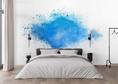 Abstract blue powder explosion. Closeup of blue dust particle splash isolated on white background Wall mural