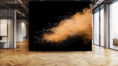 Abstract brown powder explosion. Closeup of brown dust particle splash isolated on black background Wall mural