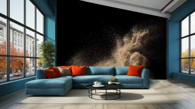 Gold sand explosion isolated on black background. Abstract sand cloud. Wall mural