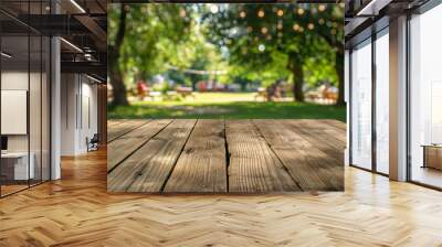 Empty wooden table in summer background with the blurred green garden and party in the background. Wall mural