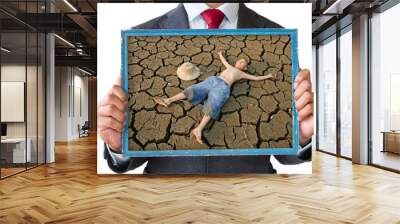 Businessman hand holding frame with children looking lay down  on cracked earth picture. Drought, Ecology World Environment Day, Climate change, Global warming and Pollution concept. Wall mural