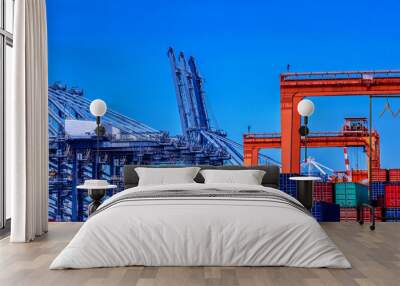 container cargo freight ship in container terminal yard is loading in sea port Wall mural