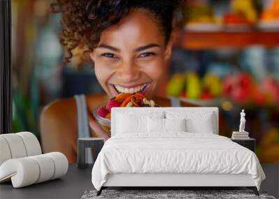 A happy woman enjoying a variety of nutritious snacks like nuts and dried fruits Wall mural