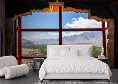 Amazing scenic view through the window of Thiksay Monastery or Thiksay Gompa to the green valley village of the Indus river, Leh Ladakh, Jammu and Kashmir, India. Wall mural