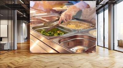 Chef standing behind full lunch service station with assortment of food in trays. Wall mural