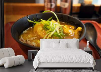 Japanese curry rice with beef in a black bowl on table with nature light through the window. Wall mural