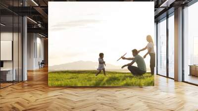 Asian children playing cardboard airplane together in the park outdoors Wall mural