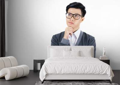 Young Asian man in white shirt and grey jacket thinking isolated on white background Wall mural