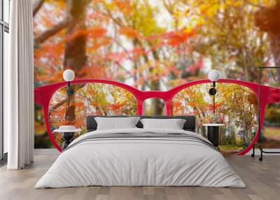 red glasses lense over autumn park background. Wall mural