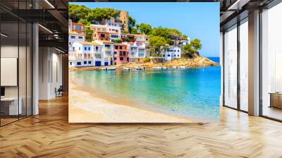 Colorful houses in sea bay with beach in Sa Tuna coastal village, Costa Brava, Spain Wall mural