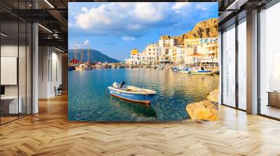 Fishing boat in Pigadia port at sunset time, Karpathos island, Greece Wall mural