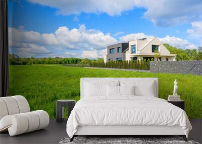 Modern house on green meadow in rural landscape of Krakow, Poland Wall mural