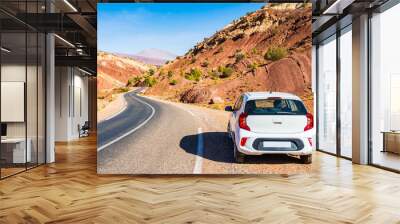 Rental car parking near paved asphalt road in Atlas mountains with high peaks and desert arid landscape near Tizi n'Tichka pass, Morocco, North Africa Wall mural