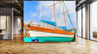 Traditional wooden sail boat in shipyard of small Greek marina, Samos island, Greece Wall mural