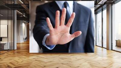 business man holding out hand, indicating stop Wall mural