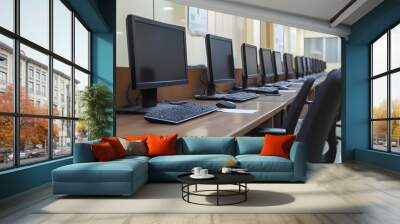 Organized computer workstations in modern office workspace with electronic equipment Wall mural