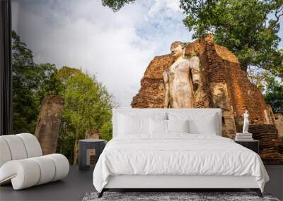 Big antique standing or walking buddha in world heritage Kamphaeng Phet historical park, Thailand. Wat Phra Si Ariyabot temple. Wall mural