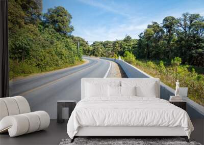 Country road on the forest mountain with blue sky in sunny day. Wall mural