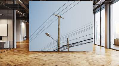 Electric pole transmission power line with blue sky background. Electrical energy and technology concept. Wall mural