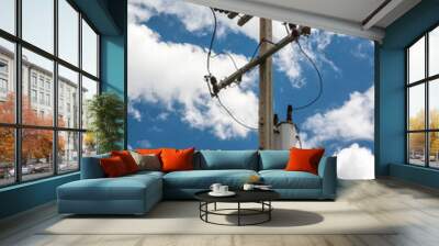 Electric pole transmission power line with blue sky background. Electrical energy and technology concept.	 Wall mural