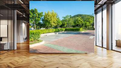 empty space in city park outdoor concrete parking lot area with blue sky in summer season. green nat Wall mural