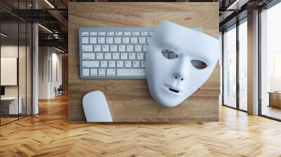 Flat lay white scary half face mask, keyboard and mouse on wooden table background in dark tone. Hacker, cybercrime, romance scam and online security concept. Wall mural