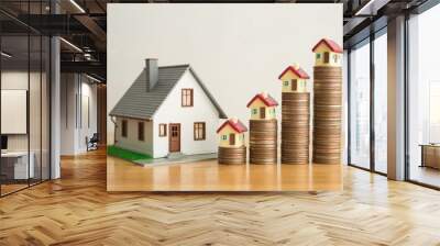 House on stack coins growth as chart on wooden table white wall background. Banking, financial, mortagage loan concept. Central bank (FED) increase interest rates effect to house price and payment. Wall mural