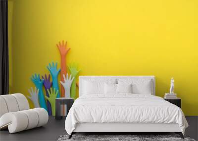 Many colorful hands up on yellow background with copy space. Concept of international human rights, equality and peace. Color hands are symbol of diversity. Wall mural