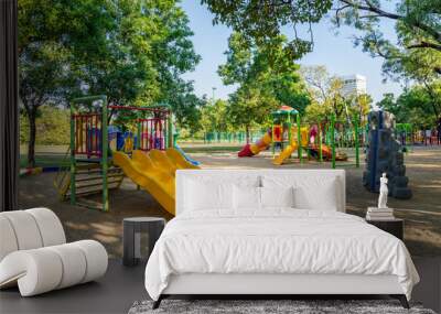 Outdoor children playground in green nature city park Wall mural