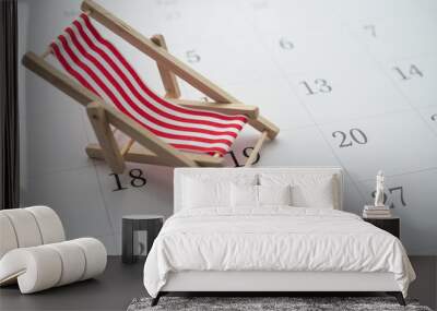 Red beach chair on white blank calendar background copy space. Annual leave travel period for relaxation concept. Period of paid time off (PTO) granted to employees by their employer. Wall mural