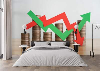 Stack coins and arrow red green graph chart volatility up and down on wooden table background. Business, financial and investment concept. Risk, fluctuation in stock market and cryptocurrency. Wall mural