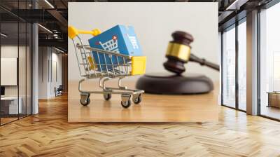 Trolley, online shopping boxes and hammer judge on wooden background. Consumer rights and responsibilities to safety, customer protection in online shopping e-commerce, commercial law concept. Wall mural