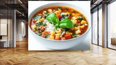 A bowl of Italian minestrone soup filled with vegetables and pasta, garnished with fresh basil and Parmesan, served on a white background for a clean presentation. Wall mural