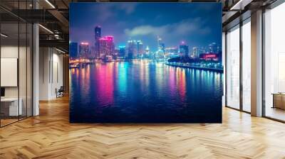 A city skyline illuminated with bright lights and reflections on a river, capturing the vibrant nightlife and urban glow against a dark night sky. Wall mural