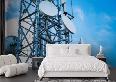 A close-up of antennas and dishes on a cellphone tower, highlighting the intricate technology involved. Wall mural