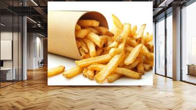 A container of French fries with some spilling out onto a white background, showcasing their crispy texture and golden color in a casual setting. Wall mural