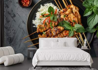 A plate of Thai papaya salad served with grilled chicken skewers and sticky rice, offering a complete and satisfying meal option Wall mural