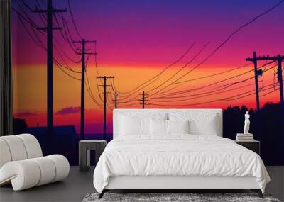 A silhouette of electricity poles and power lines against a colorful sunrise or sunset, capturing the stark contrast between the structure and the sky. Wall mural