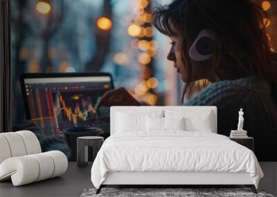 a woman studying gold market trends and performance on a laptop screen with a cup of coffee, showcas Wall mural