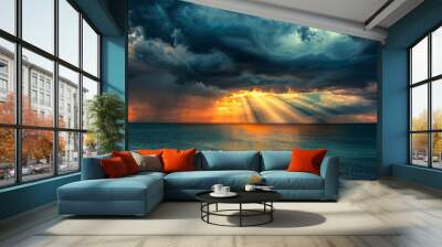 Dramatic sunset after a storm, with rays of sunlight breaking through dark clouds over a calm sea. Wall mural