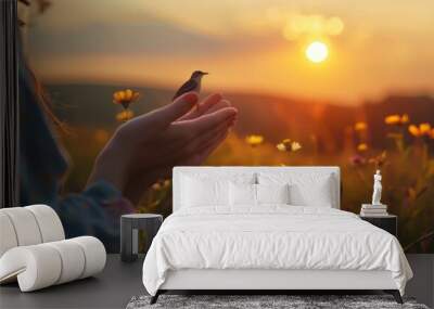 Woman hands praying and free bird enjoying nature on sunset background, hope and faith concept Wall mural