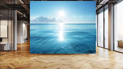 A serene blue ocean scene with  blue waters, blue sky  and sunlight reflecting on water, blue sea and sky background,banner panorama tranparent water sea Wall mural