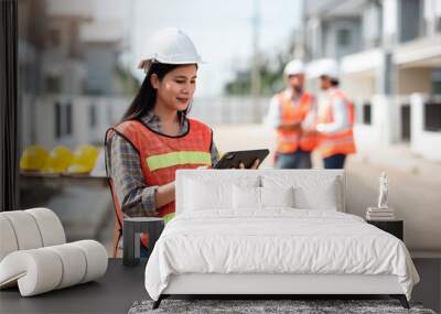 Construction worker, Engineering or architect woman using digital tablet for work at construction site , Engineer female inspection at real estate project. Wall mural