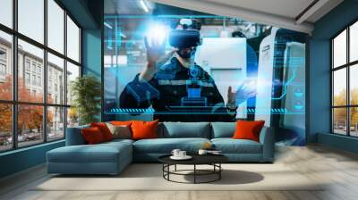 Engineering male wearing VR glasses for simulate control automation robotic arm welding machines in modern factory warehouse. Innovation artificial intelligence technology for industrial revolution. Wall mural