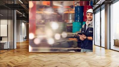 Smart factory worker engineering manager working at industrial worksite , wearing hard hat for safety Wall mural