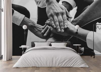 close up picture of hands of multiethnic business team touching in circle for sign of unity and integrity. monochrome Wall mural