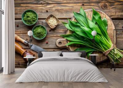 Ingredients for a wild garlic pesto recipe, fresh ramson leaves and an antique knife on rustic wooden background, ramson Wall mural