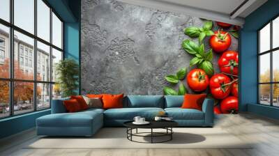 Top view of vibrant red tomatoes with green leaves on a textured concrete background Wall mural