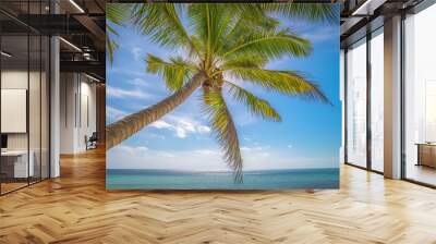 Coconut palm trees against blue sky and beautiful beach Wall mural