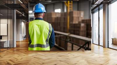 Back view of an industrial worker working on a project, wearing a safety vest and hard hat, safety concept Wall mural